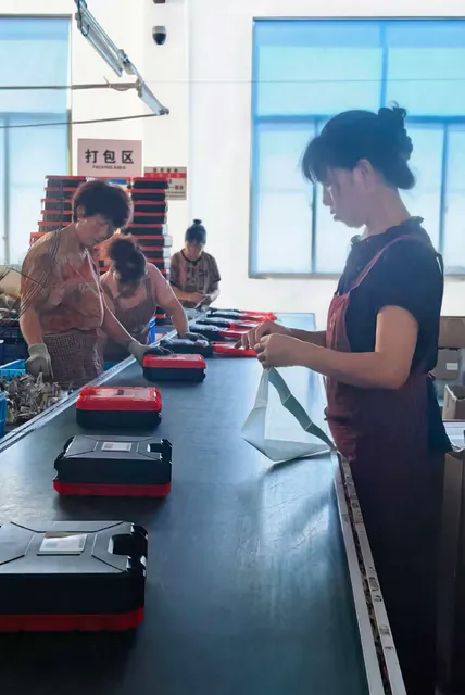 Workers preparing tool cases in the OEM factory packing area