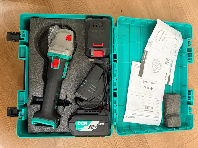 DCA ADSM06-100E photographed kit with two 6.0 Ah batteries